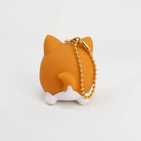 Orange cat-shaped keychain with a gold chain on a white background