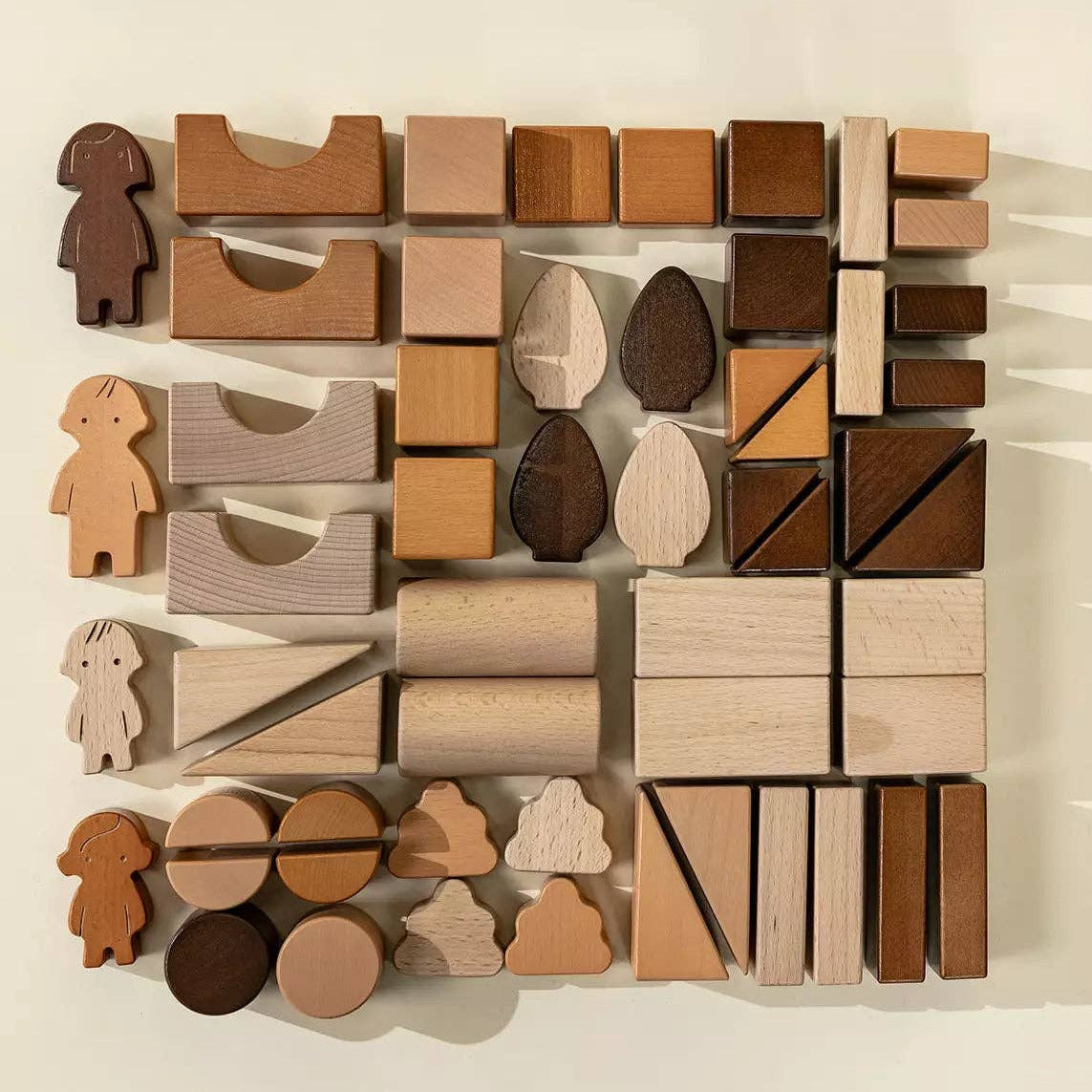 Set of wooden building blocks arranged in a pattern on a light background