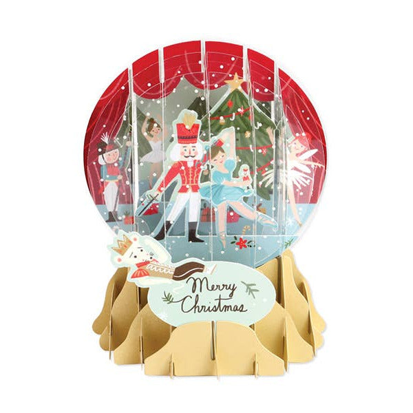 Decorative snow globe with Christmas scene and 'Merry Christmas' card on a white background