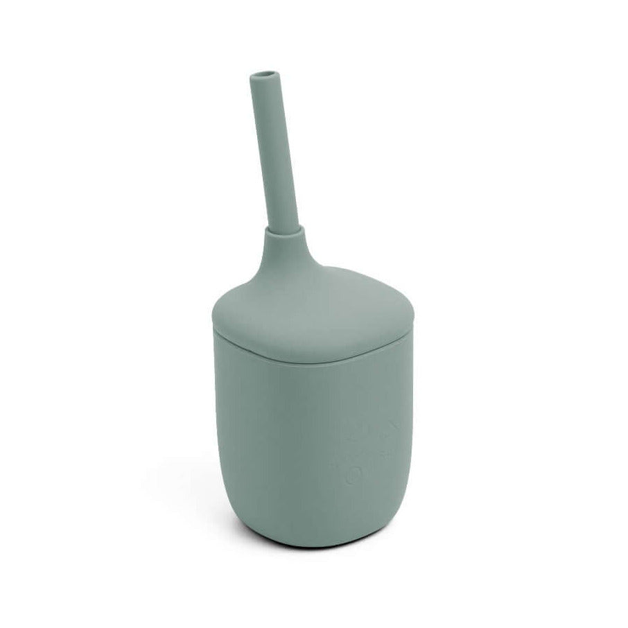 Sleek, light green cup with a long straw on a white background