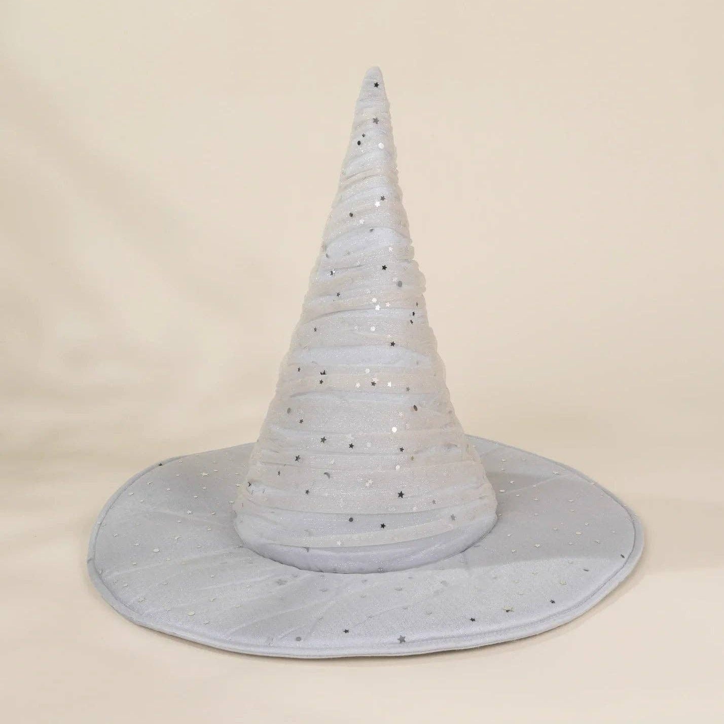 A light blue glittery witch hat with a wide brim, photographed against a neutral cream-colored background.
