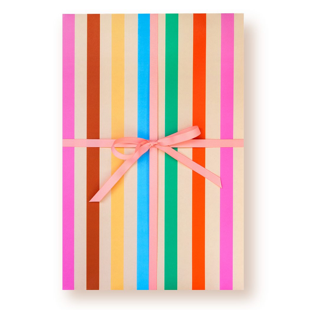 Gift box with colorful striped pattern and pink ribbon on a white background