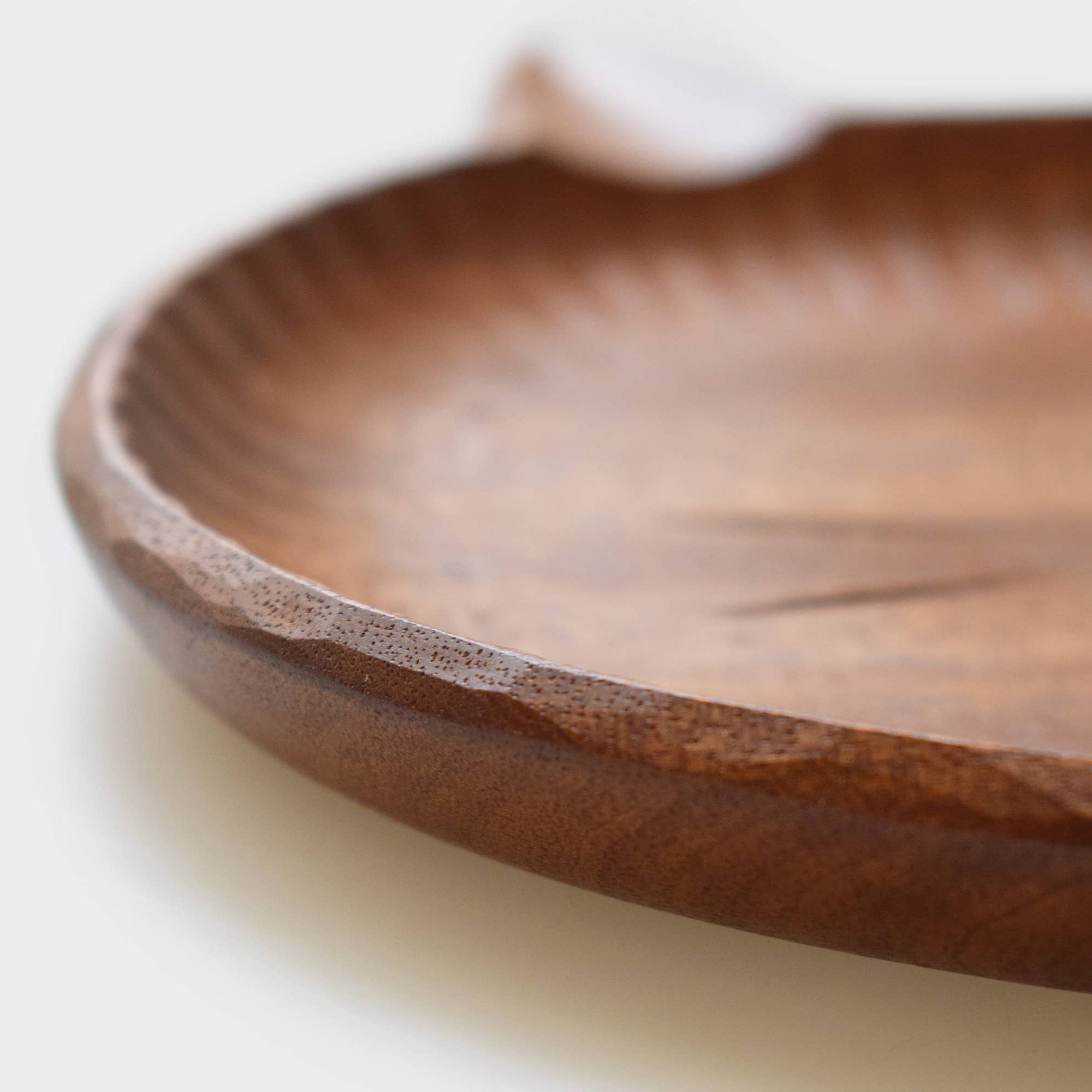 Close-up of a wooden plate on a light background