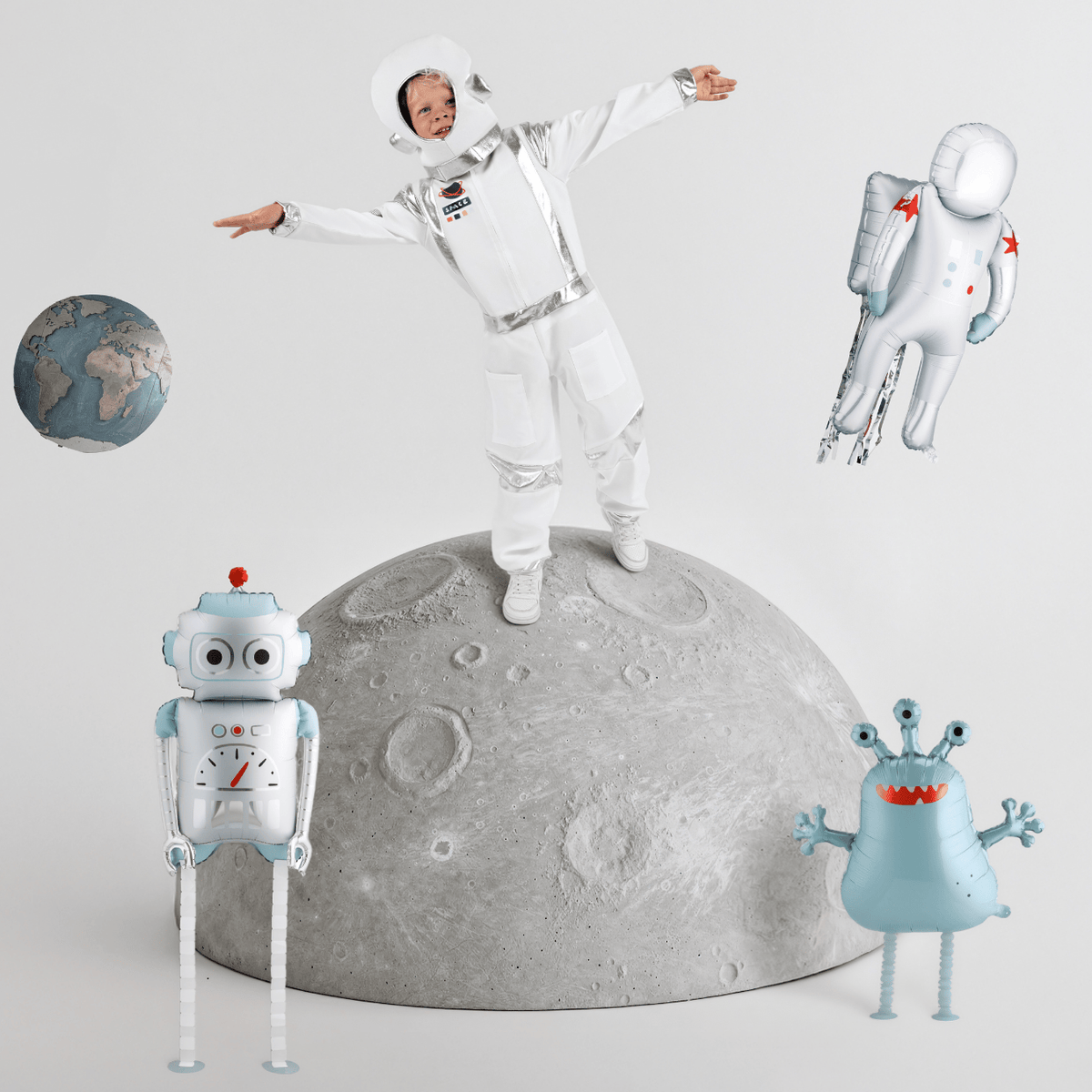 Child in astronaut costume standing on a moon-like surface with space-themed toys around.