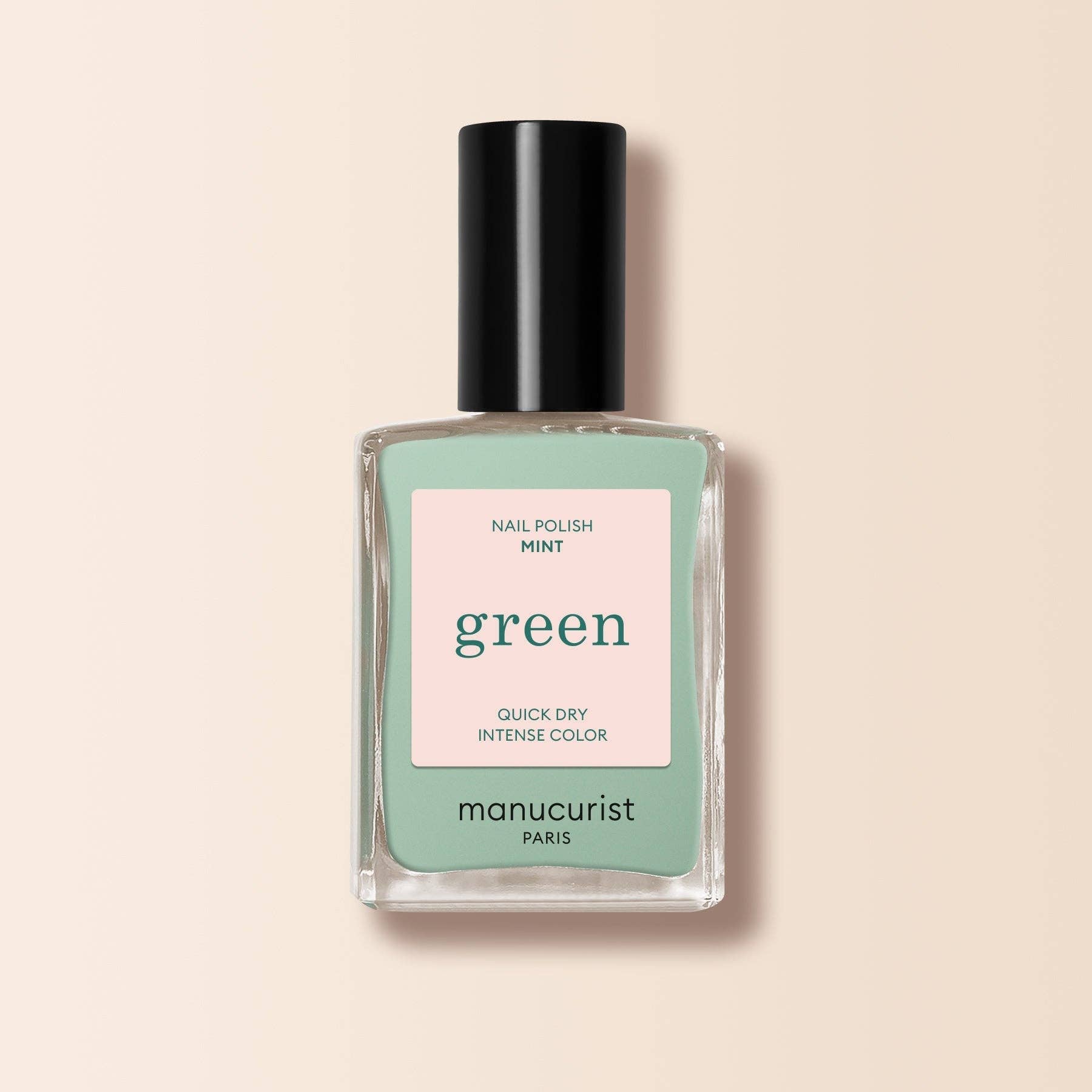 Manucurist nail polish bottle with green color on a beige background