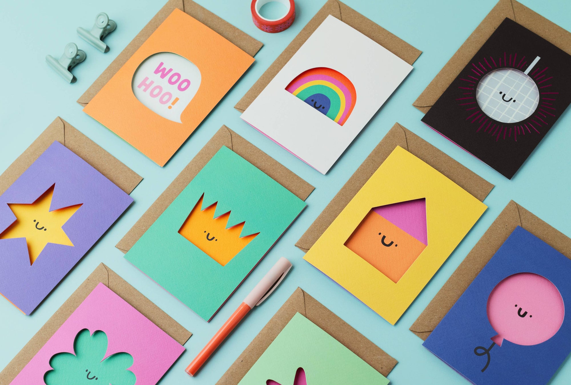 Colorful greeting cards with various designs on a light blue background