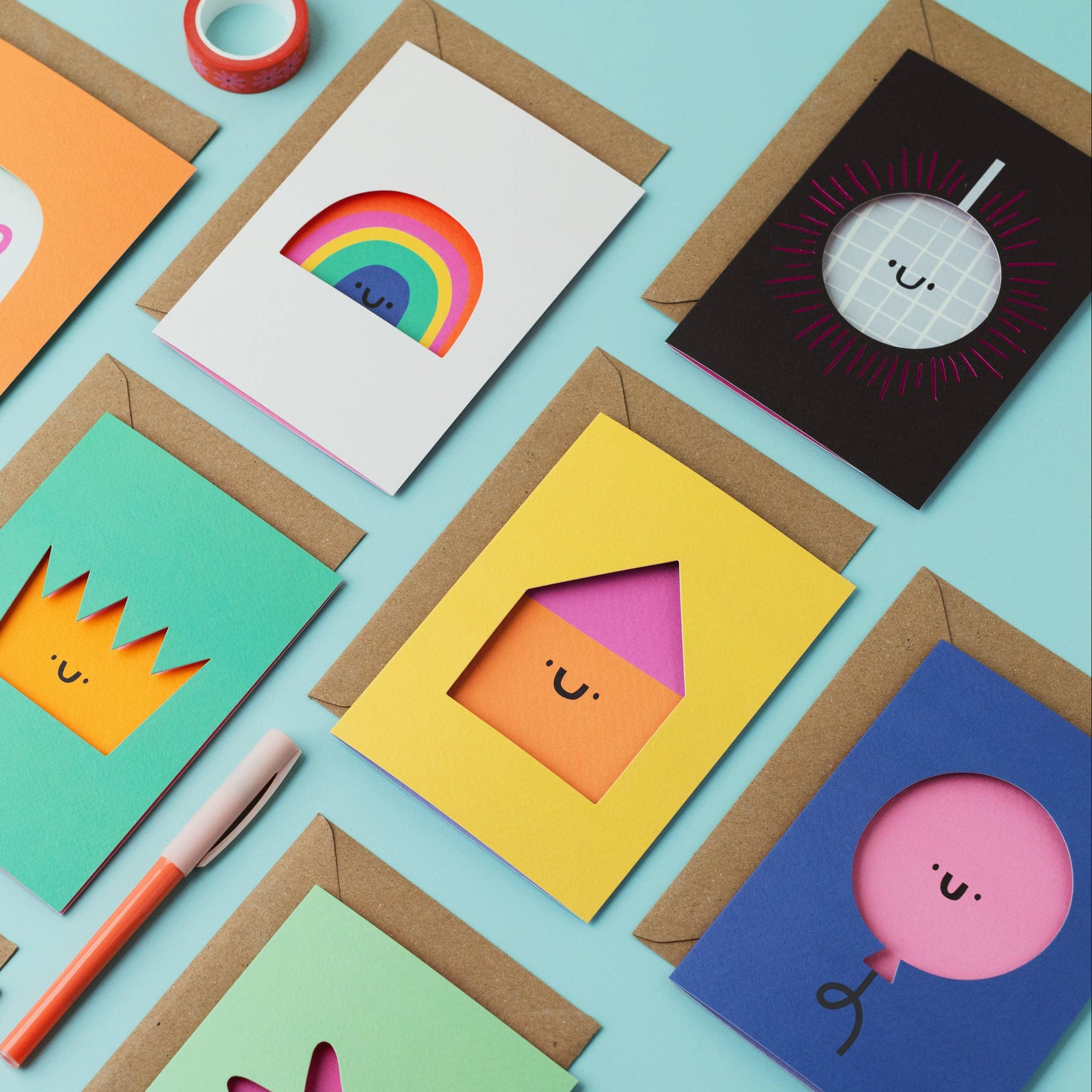 Colorful greeting cards with various designs on a light blue background