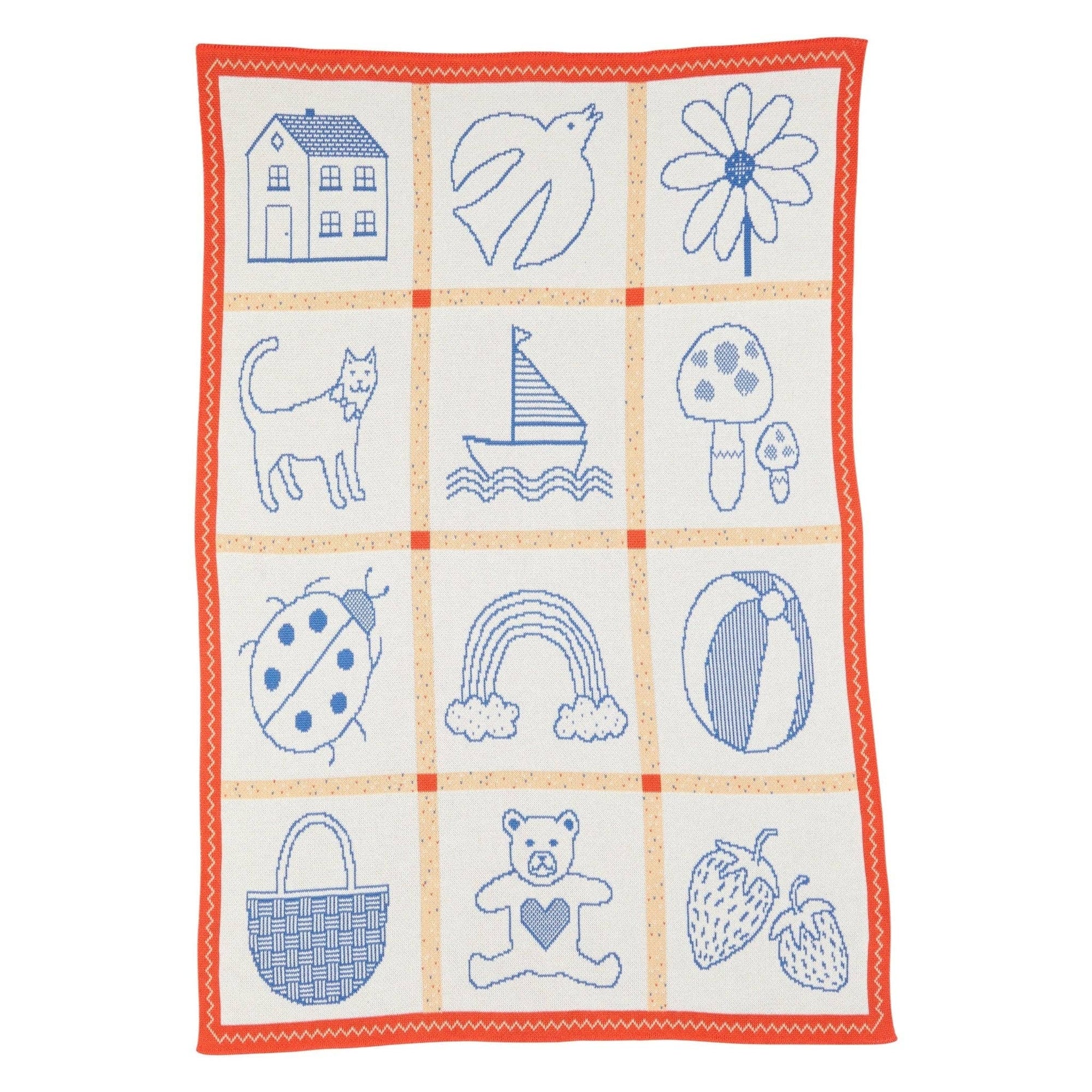 Children's blanket with blue embroidered patterns on a white background