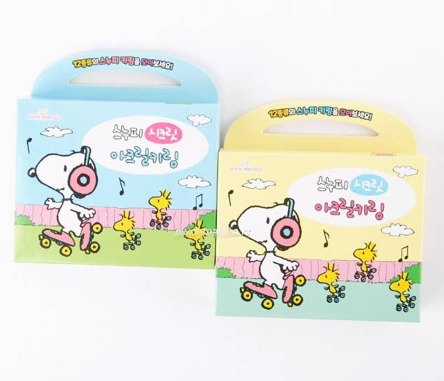 Two colorful gift boxes featuring Snoopy and Woodstock on a white background