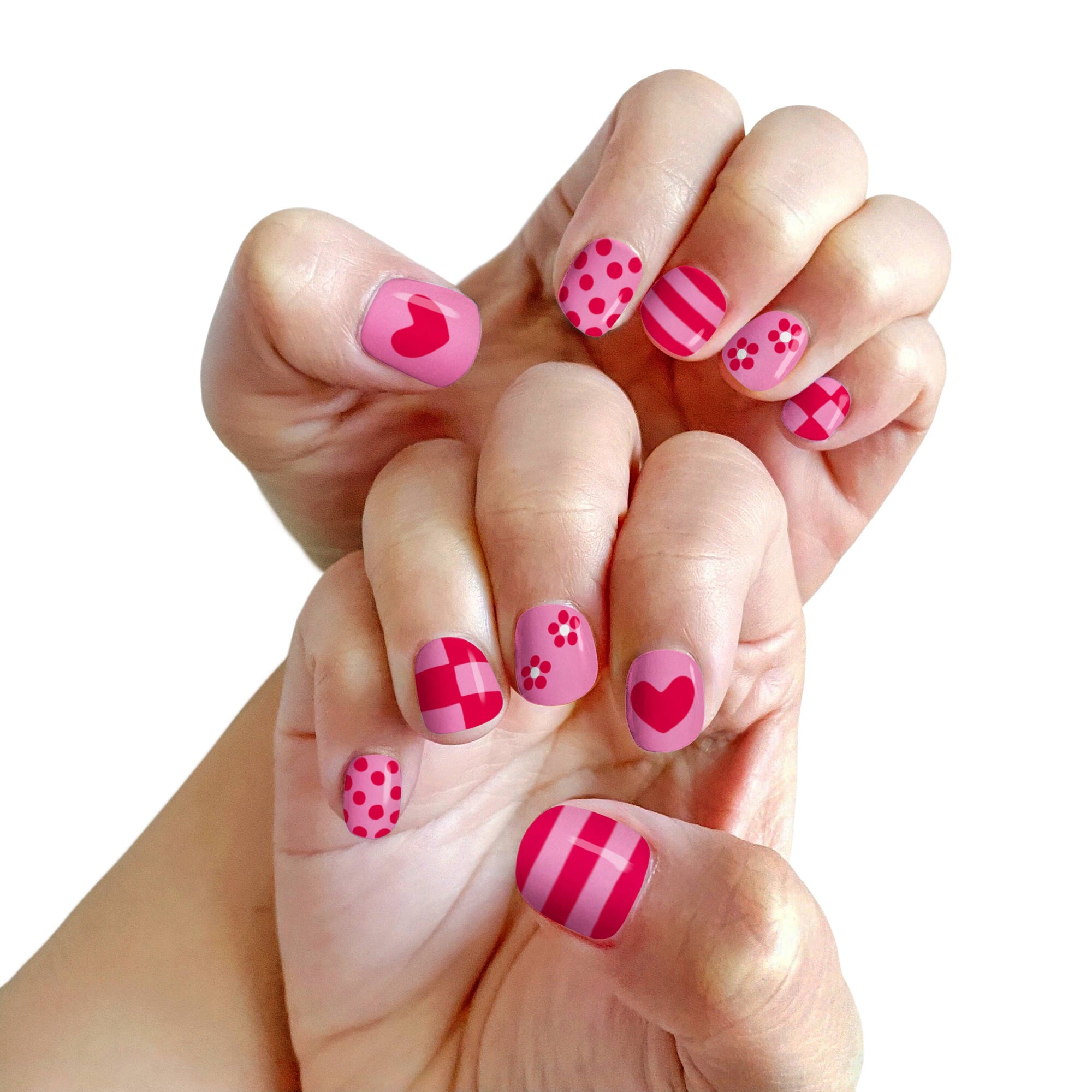 Close-up of hands with pink nail designs on a white background