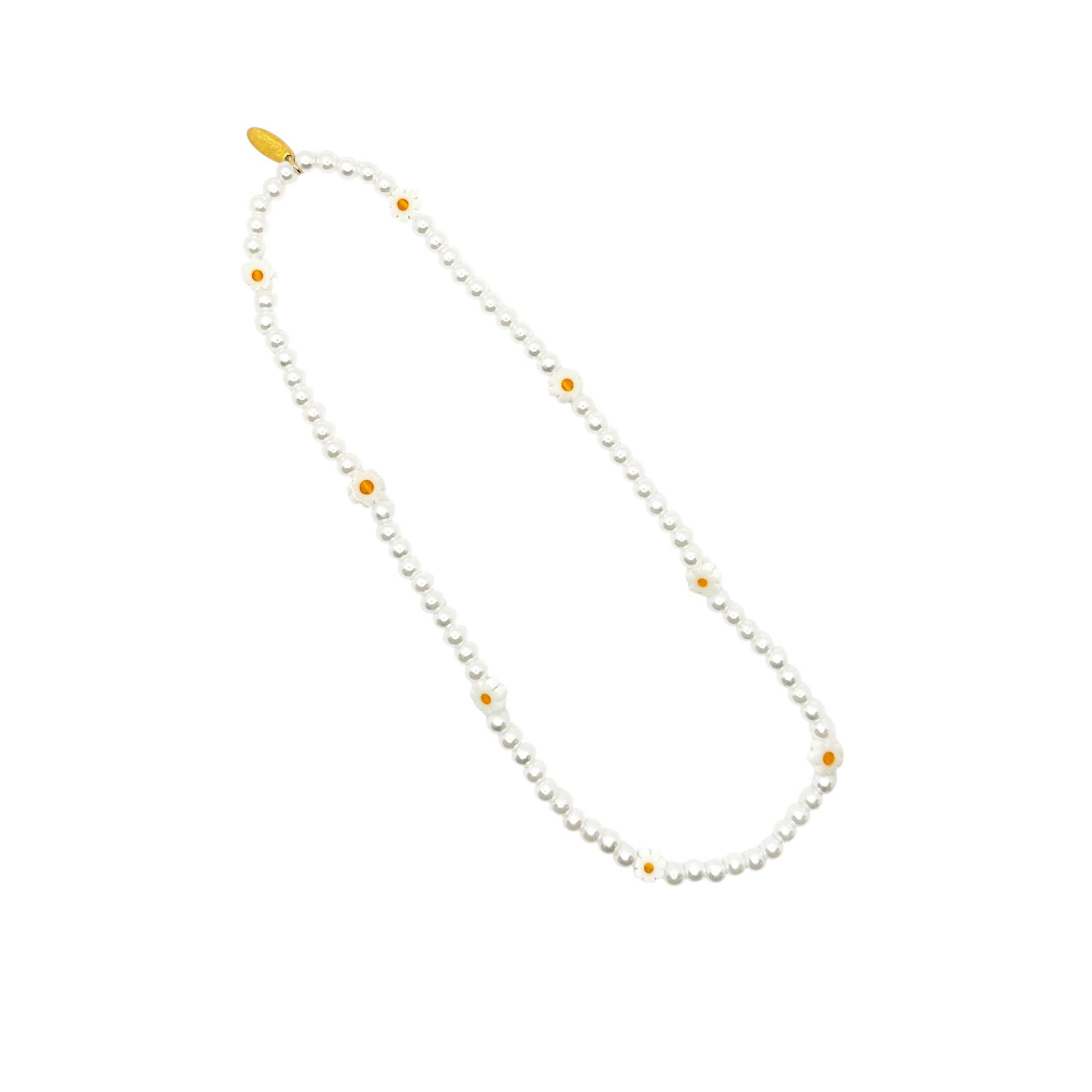 Pearl necklace with small yellow beads on a white background