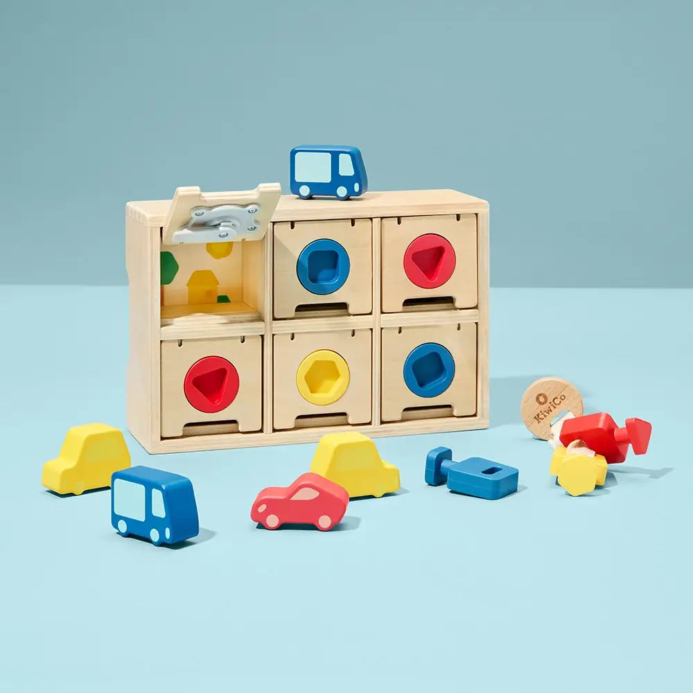 Colorful wooden toy set with shape sorting blocks and toy cars on a light blue background