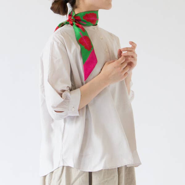 Person wearing a colorful scarf on a white background