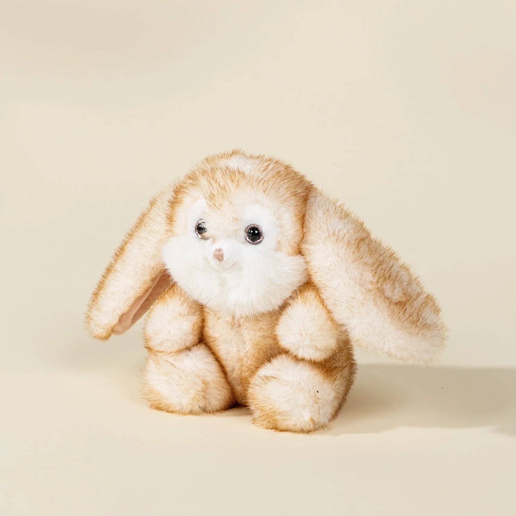 Plush toy rabbit on a beige background