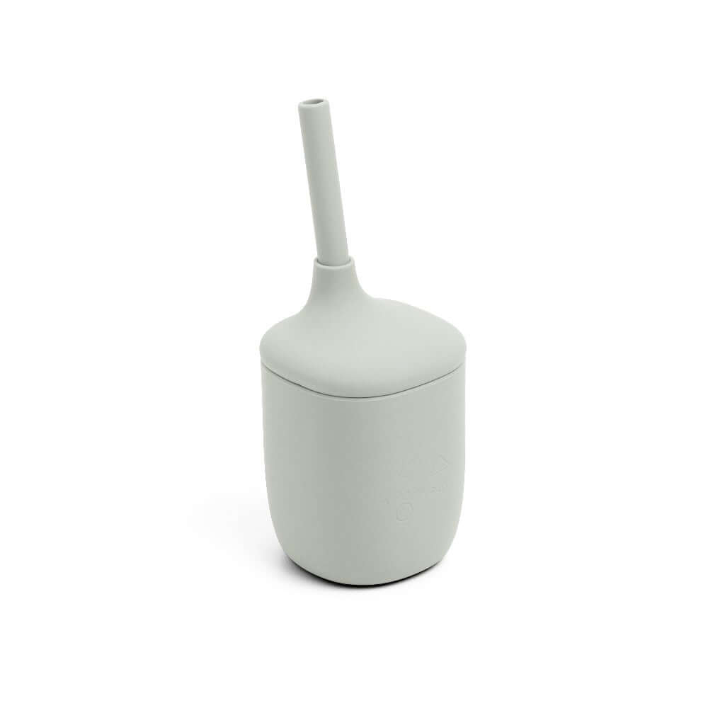 White sippie cup with a handle on a white background