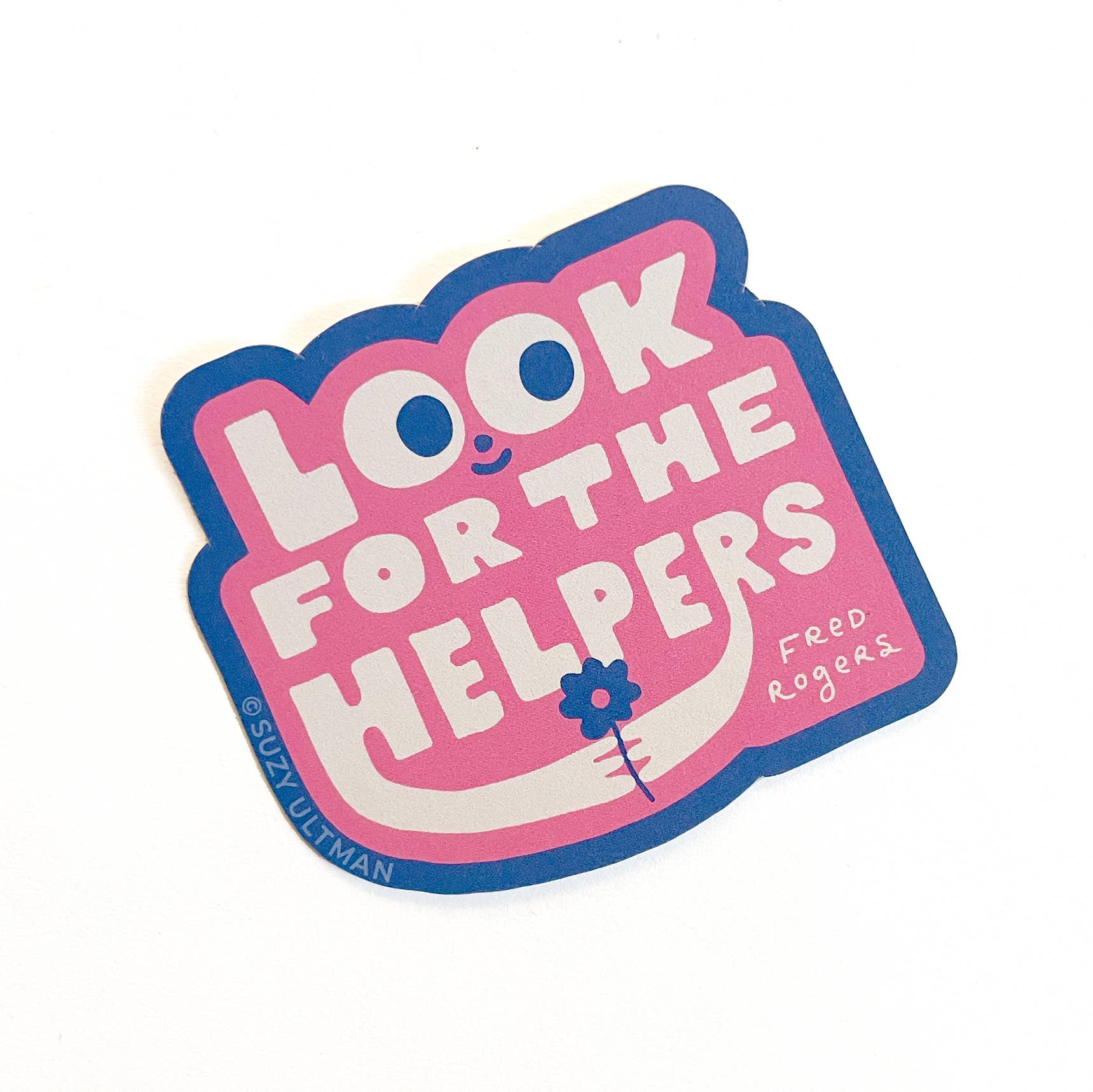 Sticker with 'Look for the helpers' text on a pink background