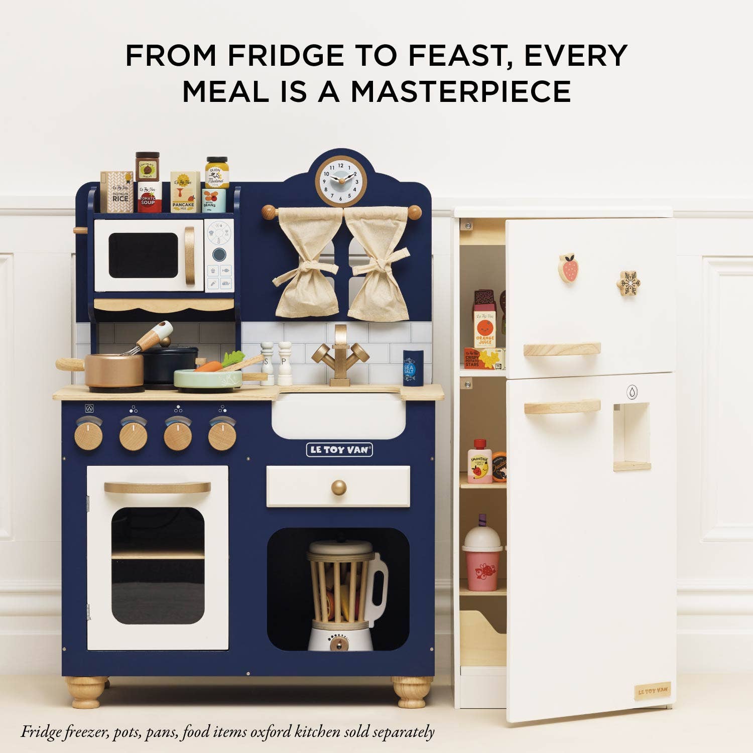Children's toy kitchen set with a refrigerator, microwave, and various appliances on a white background.