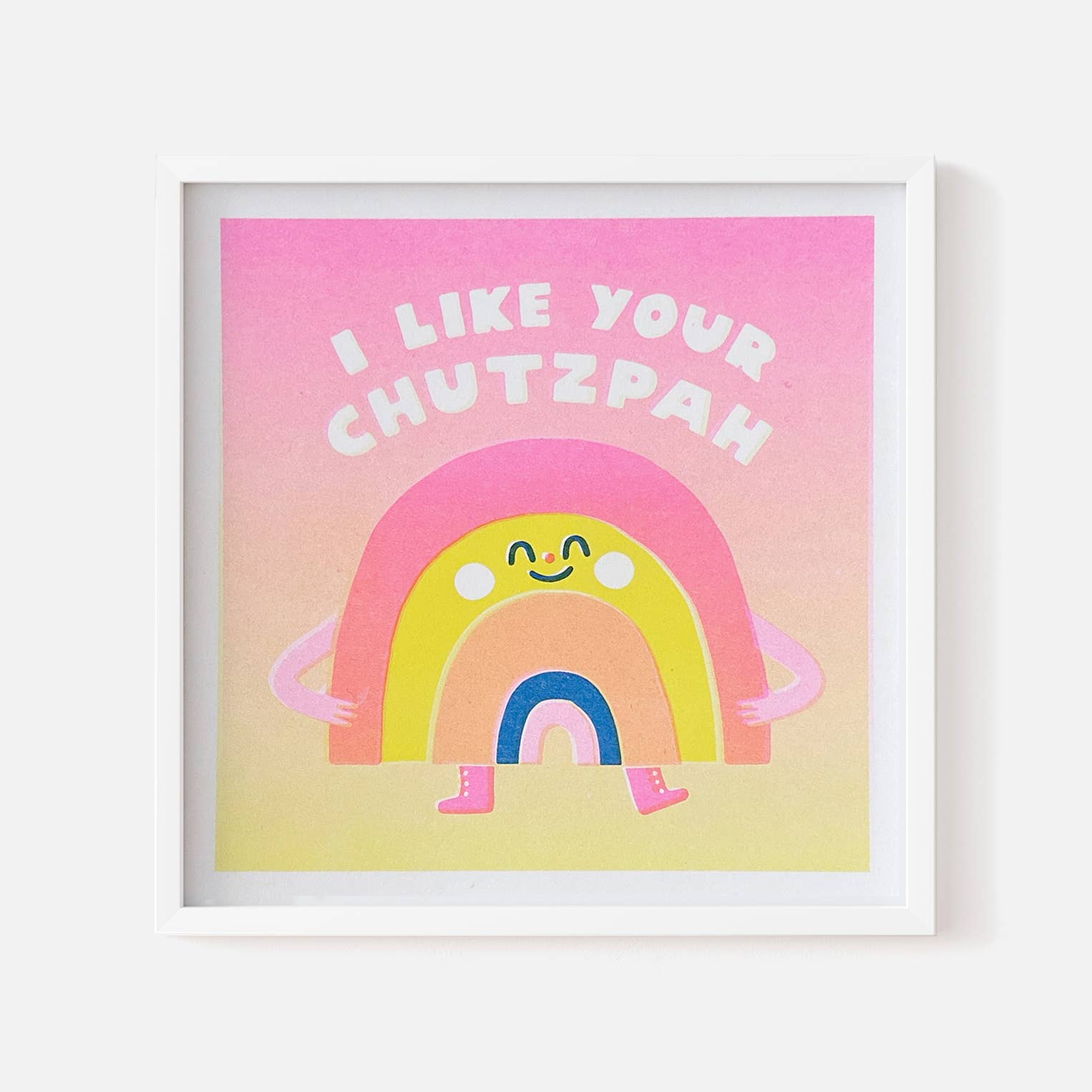 Framed artwork with a rainbow and text on a pink and yellow gradient background