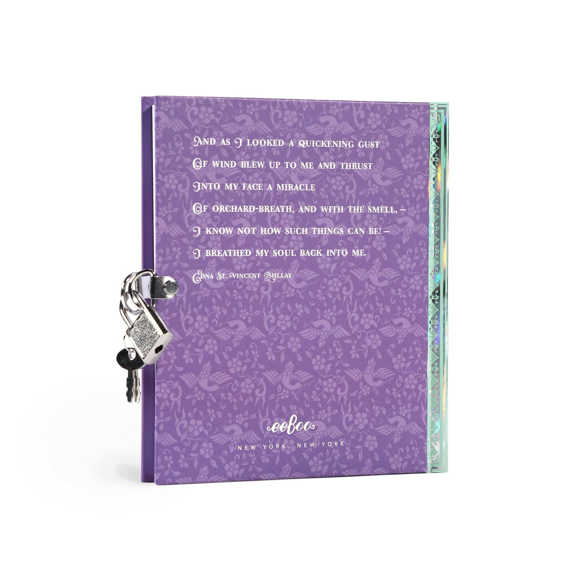 Purple notebook with decorative keychain and text on a white background