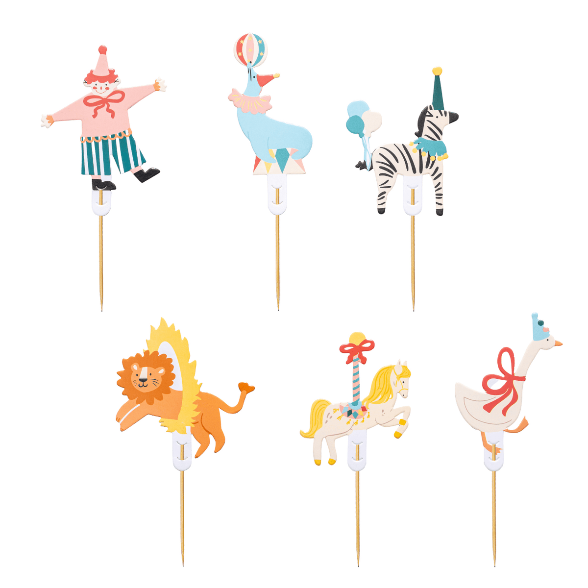 Six colorful circus-themed cake toppers on wooden sticks, including a clown, a blue animal, a zebra, a lion, a carousel horse, and a goose, shown on a plain white background.