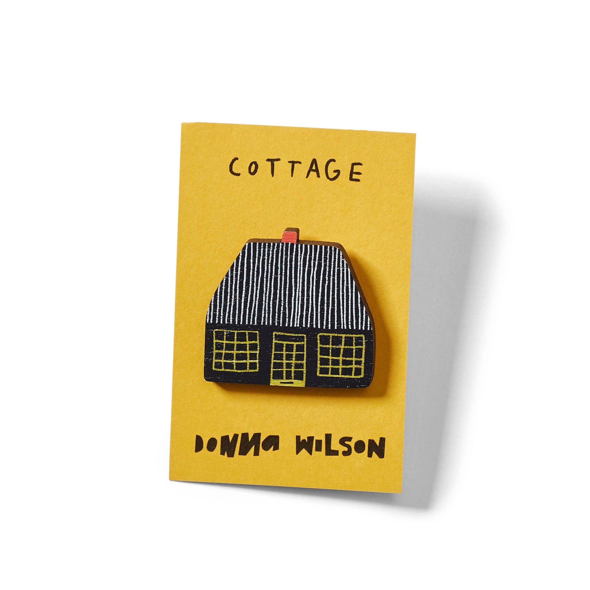 Pin with house design on a yellow card with 'Cottage' and 'Donna Wilson' text