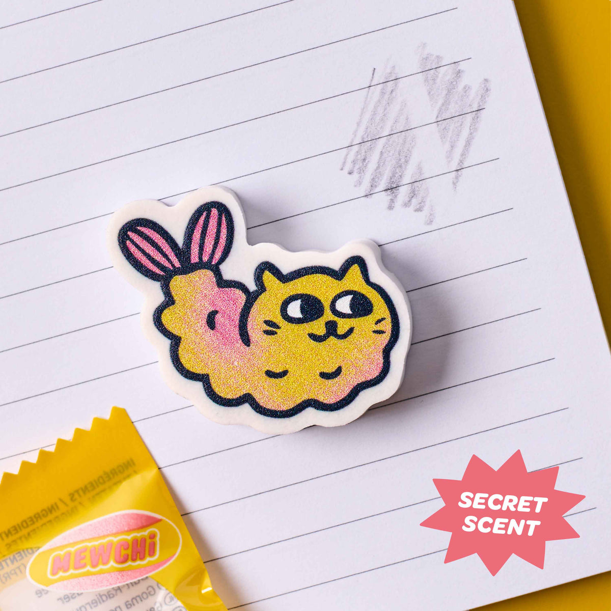 Cat-shaped eraser with secret scent on a piece of paper
