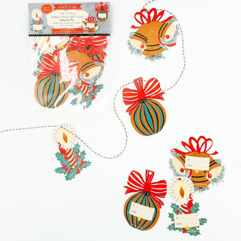 Decorative paper ornaments with ribbons on a white background