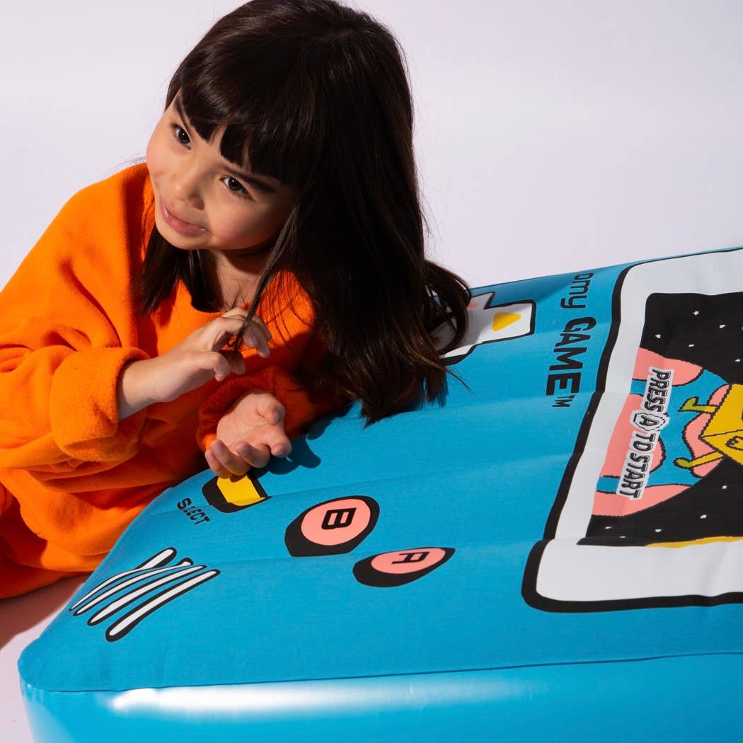 Child playing with a retro-style gaming console