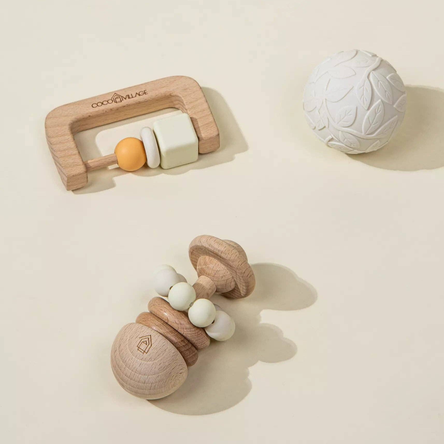 Wooden baby teething toys on a beige background
