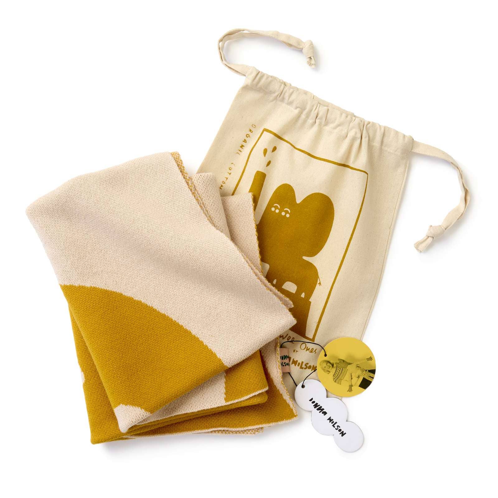 Folded beige and mustard yellow fabric with a drawstring bag featuring a logo on a white background