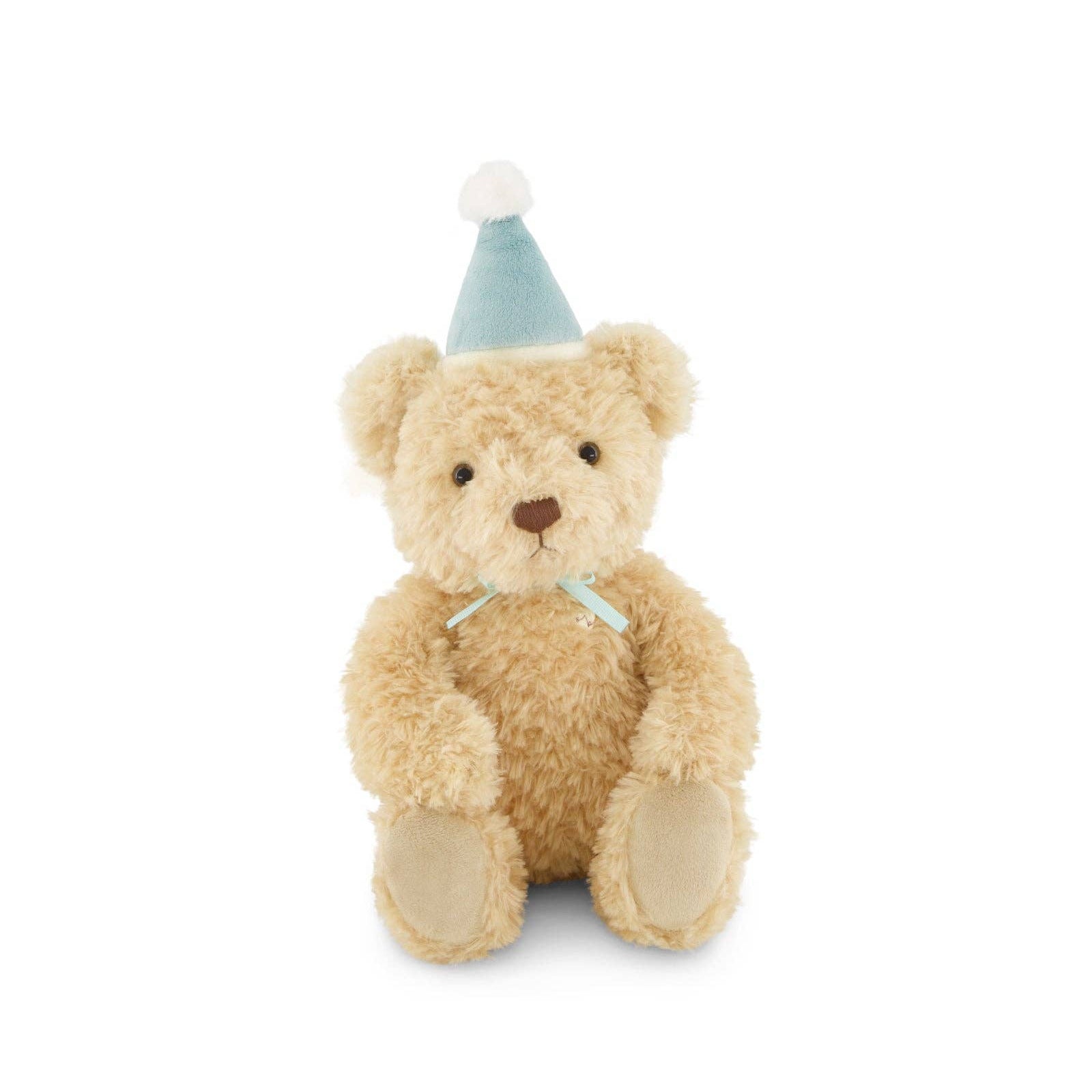 Stuffed teddy bear wearing a small party hat on a white background