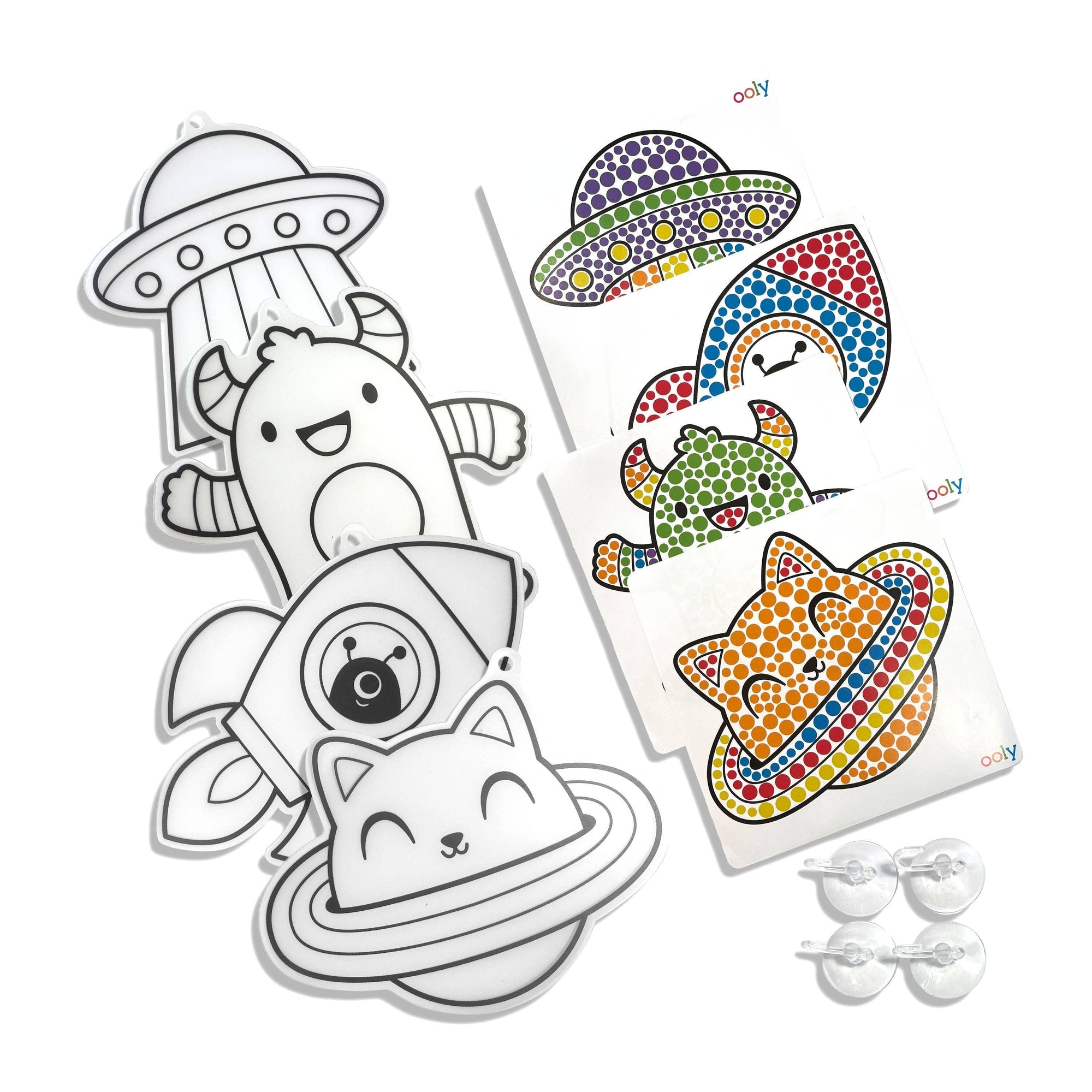 Coloring sheets with space-themed designs and clear plastic markers on a white background