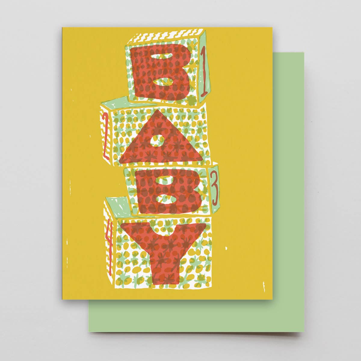 Greeting card with colorful baby blocks design on a yellow background