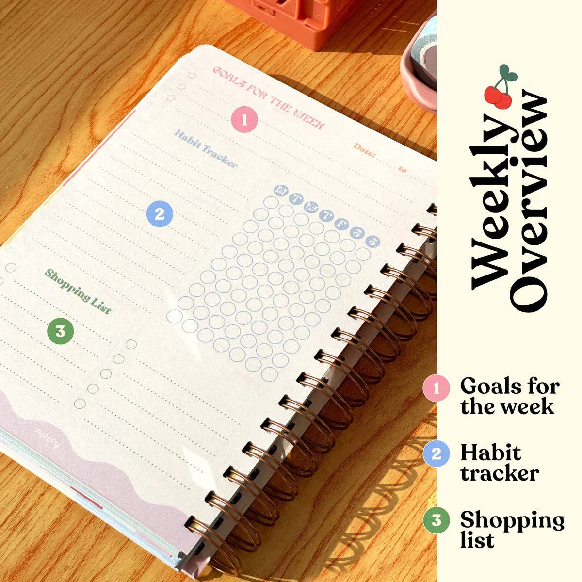 Weekly planner with habit tracker, goals for the week, and shopping list on a wooden surface.