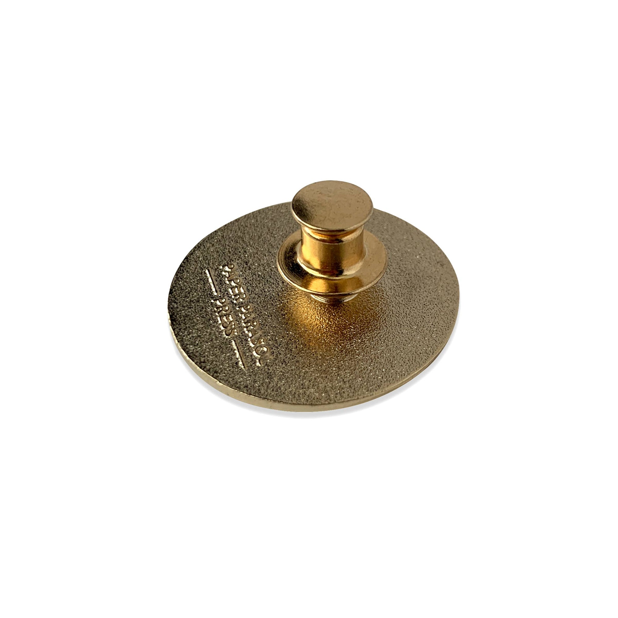 Gold metal object with a circular base and cylindrical top on a white background