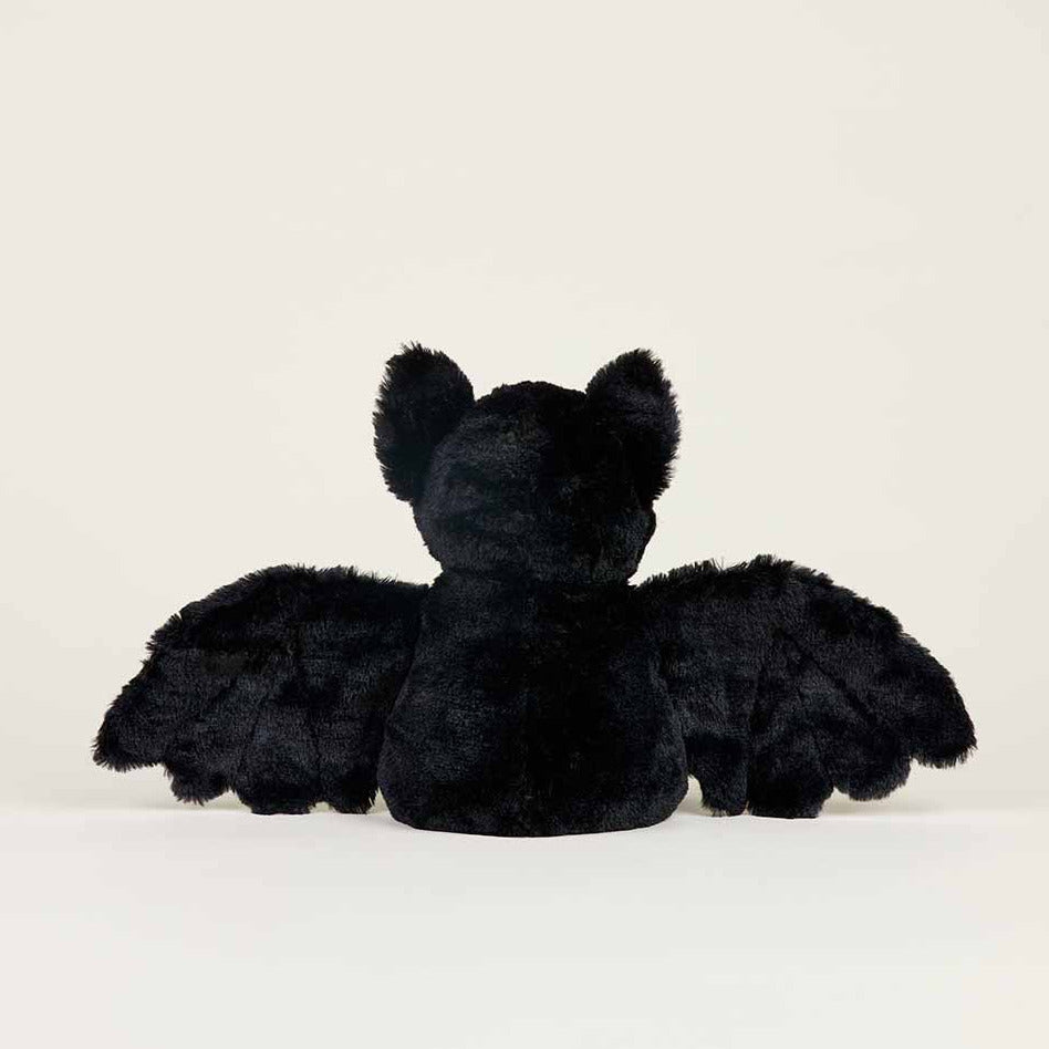 Black plush dragon toy on a white background
