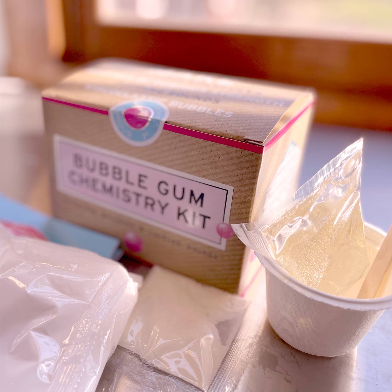 Bubble gum chemistry kit with packaging and ingredients on a table
