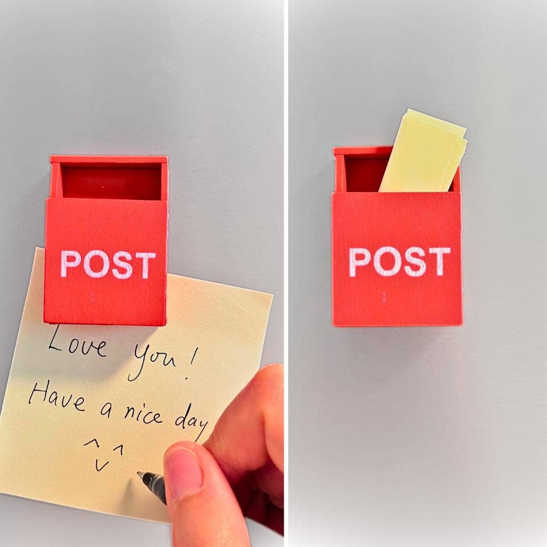 A red post box-shaped sticky note holder with the word POST in white letters, shown in two views on a light gray background. The left view shows a hand placing a handwritten note into the holder, and the right view shows the note tucked inside.