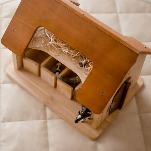 Wooden birdhouse with moving parts on a quilted surface