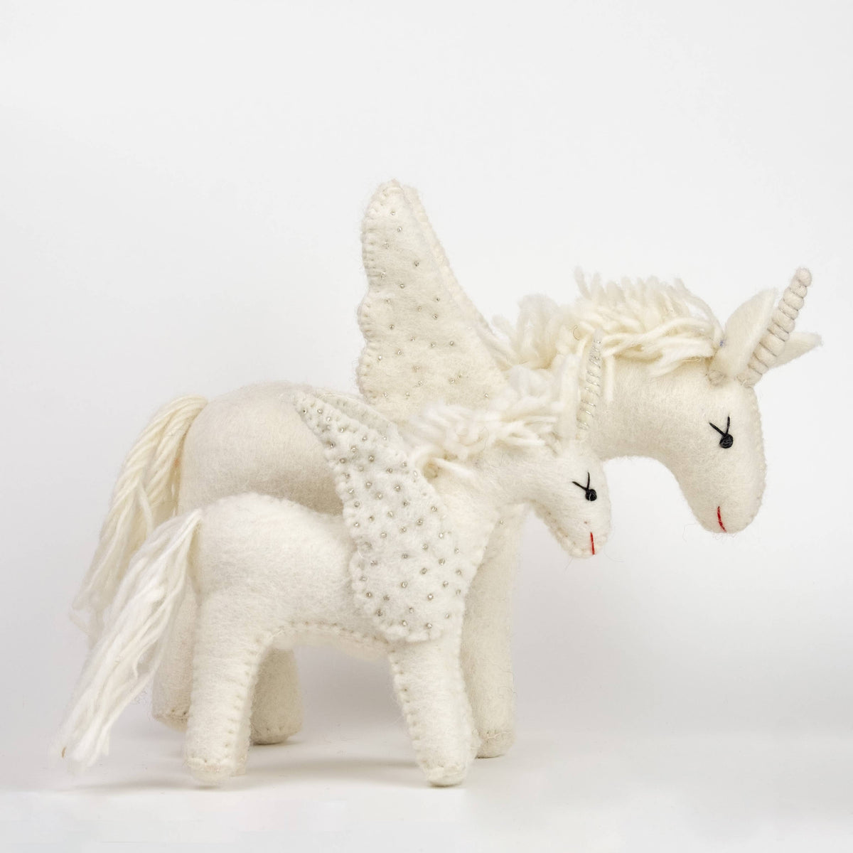 White unicorn toy with wings on a white background