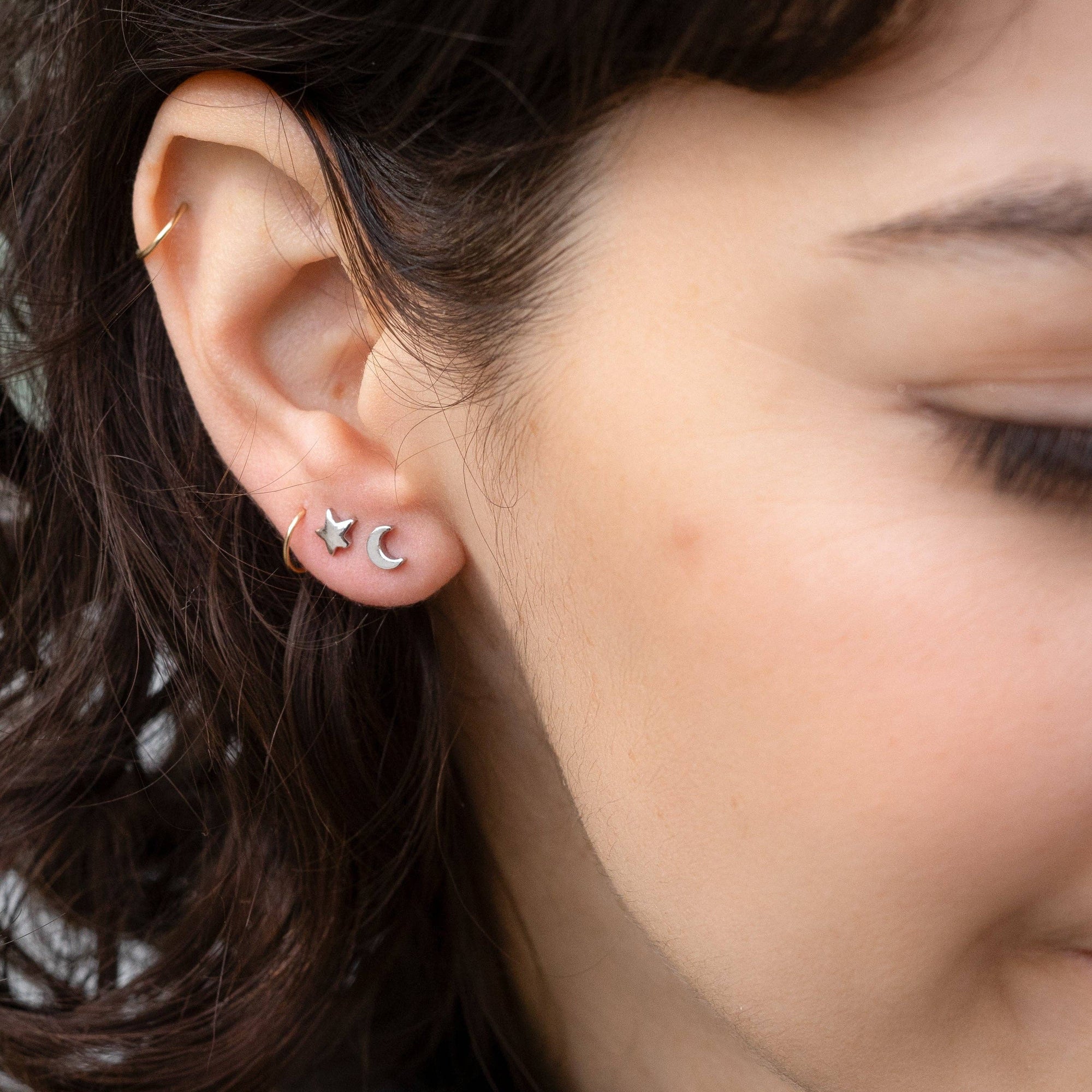 Close-up of a person wearing star-shaped earrings.