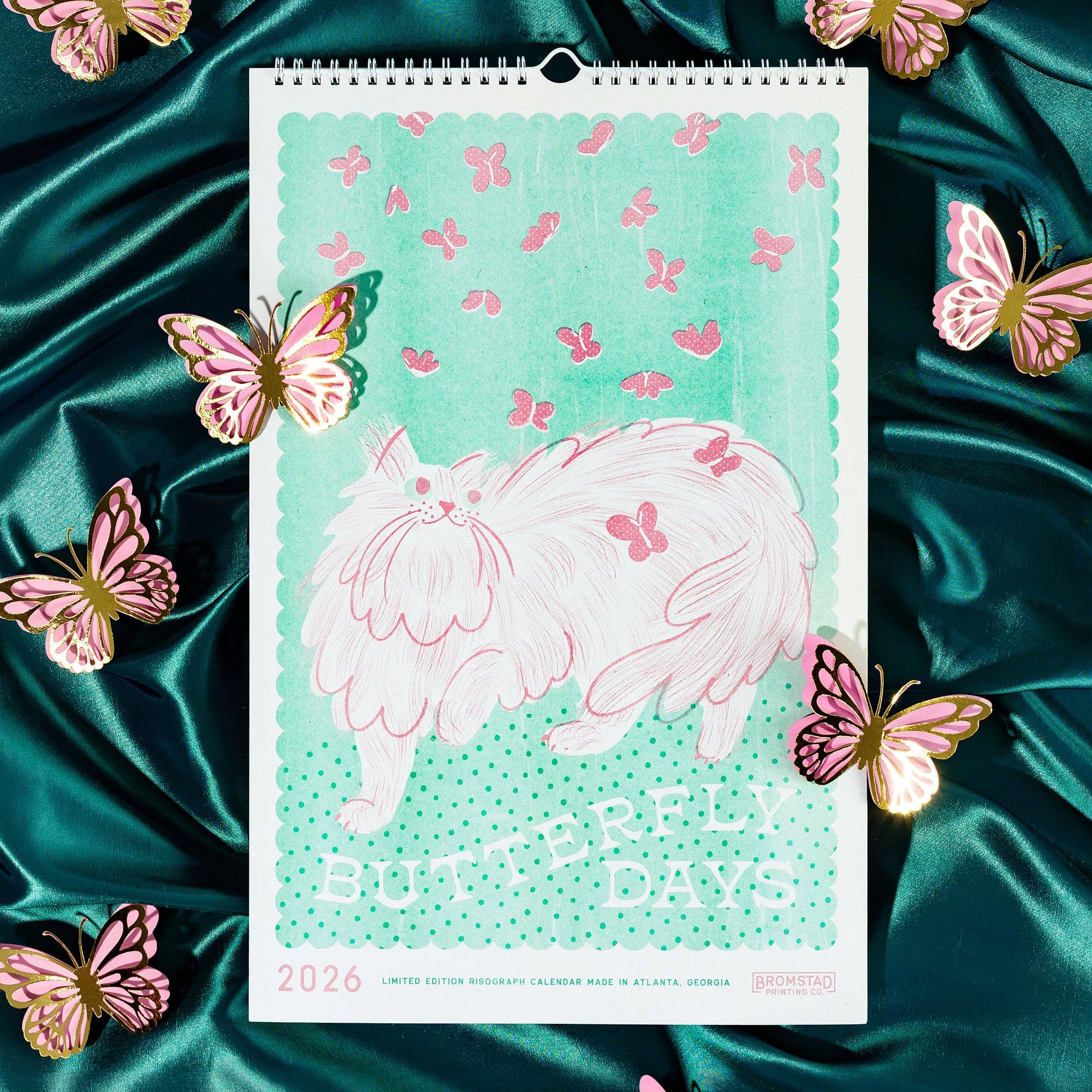 Calendar with butterfly design on a teal fabric background