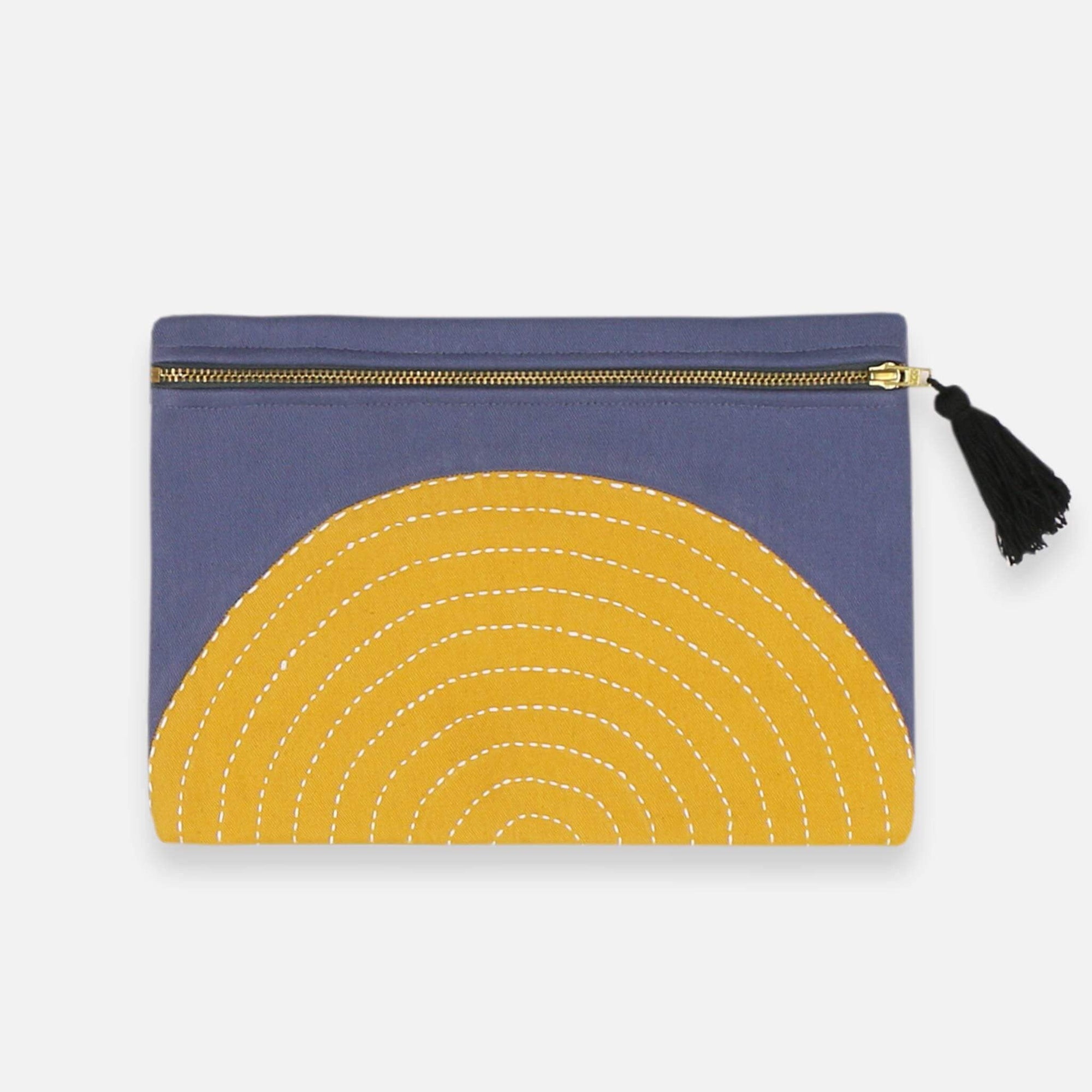 Blue pouch with yellow crescent moon design and tassel on a white background