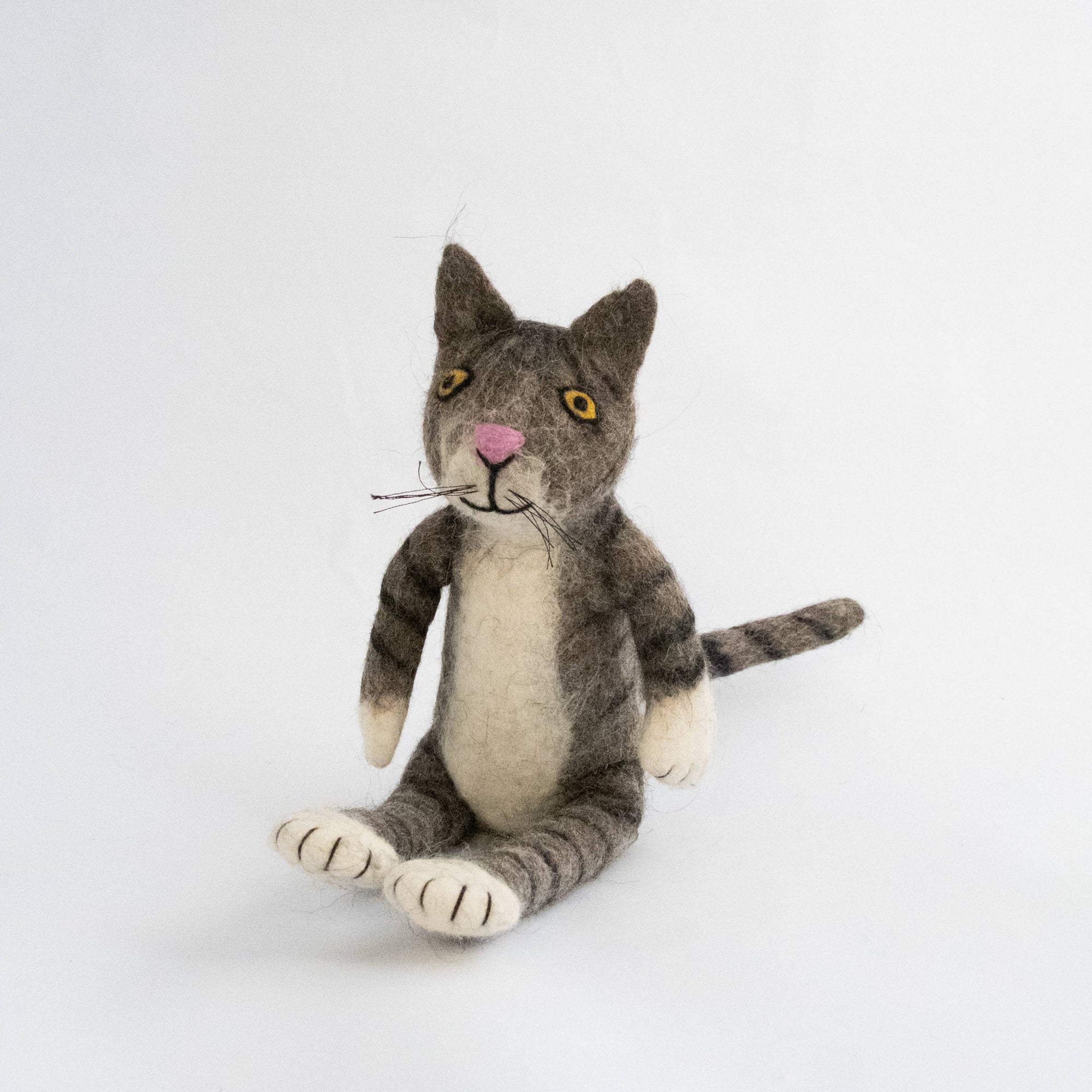 Stuffed cat toy with a gray and brown pattern on a white background