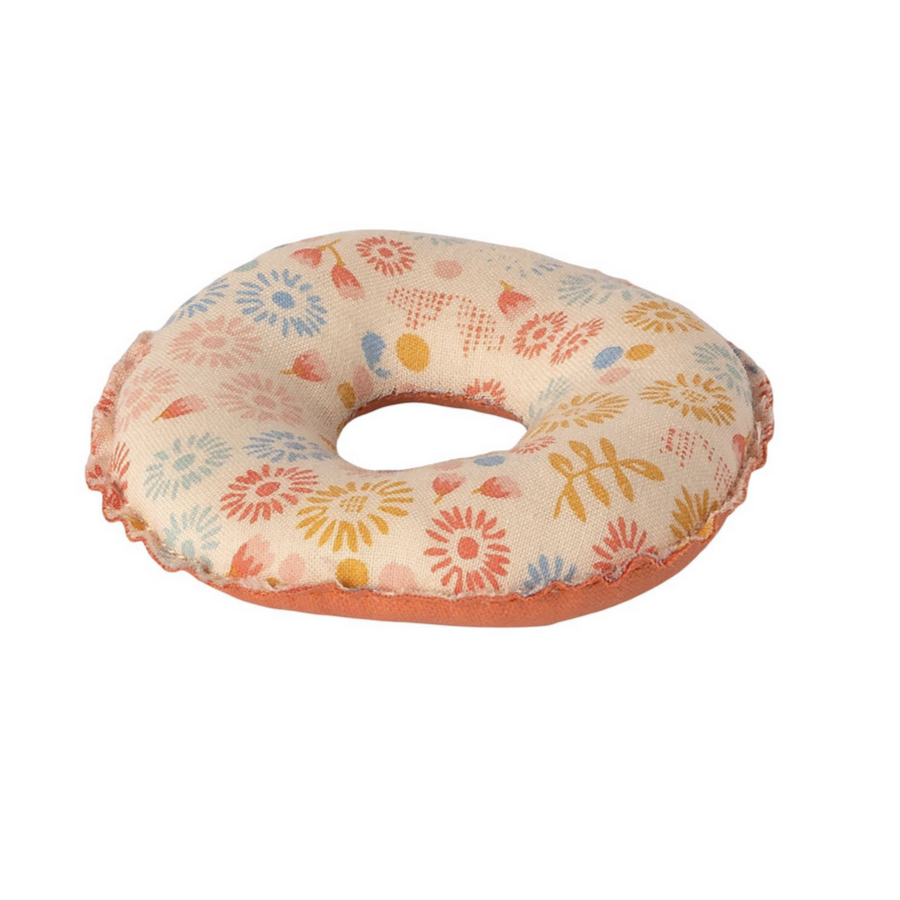 white  and pink inner tube with flowers printed on it