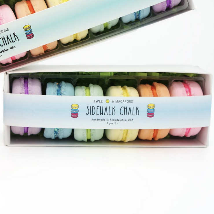 stack of colorful chalk macarons in box