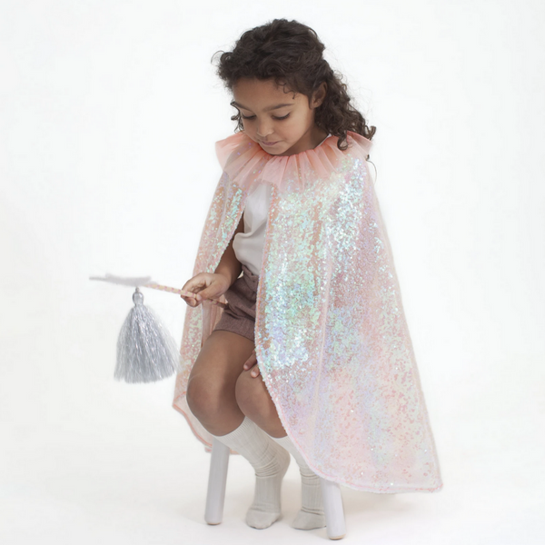 little girl wearing pink sequined cape with pink tulle collar with white star wand with silver tassle