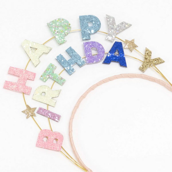 detail of headband with glitterd words above it that spell out HAPPY BIRTHDAY in pastel colors