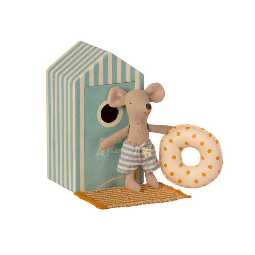 little brother mouse in swim trunks holding yellow polka dot inner tube standing on yellow striped towel standing outside of dressing room box
