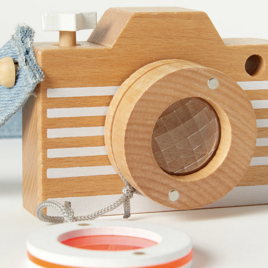 wooden camera with orange lens off showing prism lens